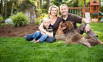 family in backyard with dog