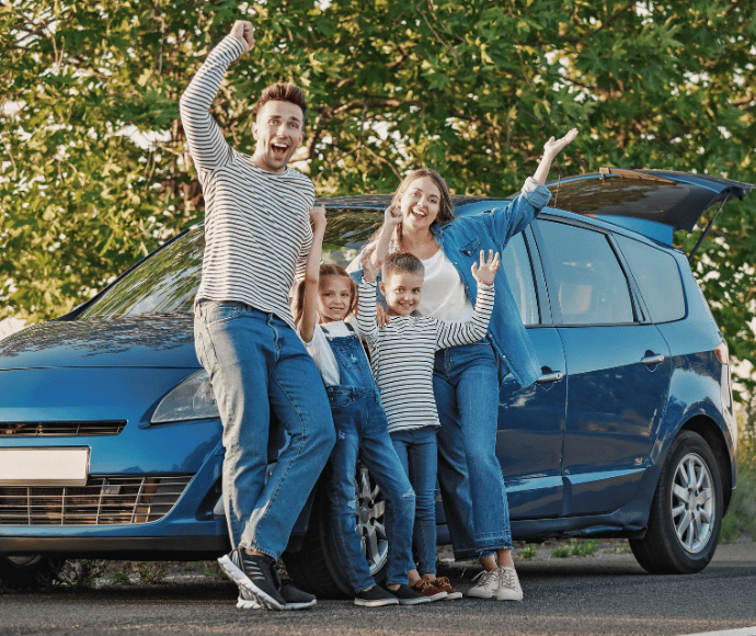Family of four in front of new car