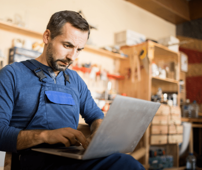 Man in workshop using laptop