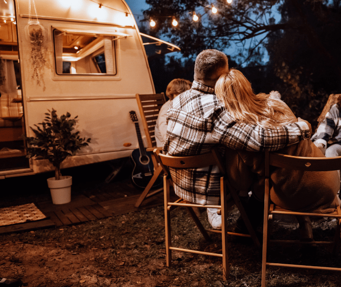 Family sitting by camper